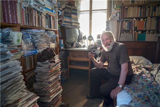 Der Bücherwurm James („Jim“) Hope, mit 82 Jahren der älteste Bewohner der Münzgasse 13, in seinem Refugium. Bild: Metz