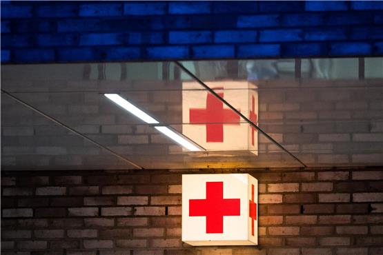 Ein Leuchtkasten mit einem roten Kreuz hängt vor der Notaufnahme eines Krankenhauses. Foto: Julian Stratenschulte/dpa/Symbolbild